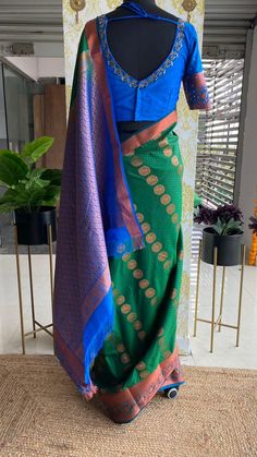 Product Descriptions: Green silk saree having copper zari border works and traditional motifs all over is paired up with contrast blue pallu having intricate copper zari weaved works. Saree comes with blue silk blouse of detailed jewel hand works on neck & sleeves Product Specifications: SAREE : * Material : Silk * Colour : green and blue * Saree length: 5.5m * Saree width : 47-49" * Works : Copper zari intricate weaved border, pallu works and traditional motifs all over the saree * Saree Add on can be select if required STITCHED BLOUSE : * Colour : Blue * Material : silk * Blouse length : 13-14”(Alterable) * Sleeve Length : 11.5" * Style : Patterned as shown in picture * Works : Detailed jewel hand works on neck and sleeves & beads works for sleeves * Blouse Add on can be selected if requ Blue Art Silk Pre-draped Saree With Traditional Patterns, Designer Blue Raw Silk Pre-draped Saree, Blue Cotton Silk Pre-draped Saree With Zari Work, Blue Cotton Silk Pre-draped Saree With Zari Weaving, Blue Pre-draped Saree With Zari Weaving For Designer Wear, Blue Banarasi Silk Pre-draped Saree With Unstitched Blouse, Designer Blue Pre-draped Saree With Zari Weaving, Designer Blue Saree With Traditional Patterns, Blue Silk Lehenga With Zari Weaving