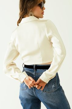 Step into spring with our elegant Satin V-Neck Cream Crop Top. This stunning piece features long sleeves, frontal pockets, and a chic wrap front with a knot detail. Crafted from 100% polyester, this crop top offers a luxurious satin finish that's perfect for any party or special occasion. The bodycon fit and tie fastening ensure a flattering silhouette, while the V-neck neckline adds a touch of sophistication. Please note that this top runs small, so consider sizing up for the perfect fit. Model Info: Model is wearing size S. Model's measurements: 33-25-35, Height: 5'7''. Key Features: Bodycon fit for a flattering silhouette. V-neck neckline and long sleeves for a stylish look. Wrap front with knot detail and chest pockets for added elegance. Made from lightweight satin fabric for a luxuri Crop Top With Long Sleeves, Tan Scarf, Cream Crop Top, Top With Long Sleeves, Neck Cream, Top Crop, Scarf Hat, Running Tops, Hat Hairstyles