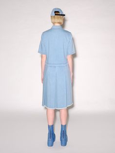 Building upon a successful series of polo-collared silhouettes, this Pre Fall 23 dress is crafted in the season’s garment-washed mid-weight denim. Designed with a relaxed fit, the drop waist silhouette gives way to wide box pleats and a frayed hem for a casual sensibility. Rosetta Getty's 10oz denim is mid-weight with a vintage feel. Offering season-spanning wear, the fabric features in styles that have been garment-washed for an inherent sense of ease. Spread collar Short sleeves Front button p Spring Collared Polo Dress For Daywear, Collared Polo Dress For Spring Daywear, Spring Cotton Collared Polo Dress, Cotton Collared Polo Dress For Spring, Blue Short Sleeve Polo Dress For Spring, Blue Casual Polo Dress For Summer, Casual Blue Polo Dress For Summer, Collared Cotton Denim Dress For Work, Cotton Collared Denim Dress For Work