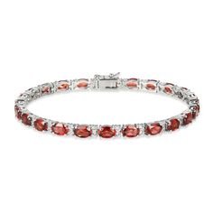 Sumptuous oval-cut garnets adorn this elegant bracelet styled in classic sterling silver. A duo of white lab-created sapphires twinkles between each link for extra sparkle. The 7.25-inch bracelet secures with a box clasp. Classic Oval Gemstone Tennis Bracelet, Red Oval Diamond Classic Bracelet, Red Oval Classic Diamond Bracelet, Classic Red Oval Diamond Bracelet, Classic Sterling Silver Oval Gemstone Bracelet, Classic Oval Gemstone Sterling Silver Bracelet, Classic Sterling Silver Bracelet With Oval Gemstone, Elegant Oval Link Tennis Bracelet As Gift, Elegant Oval Link Tennis Bracelet Gift