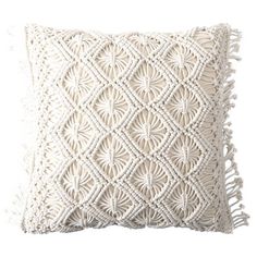 a white pillow with tassels on it