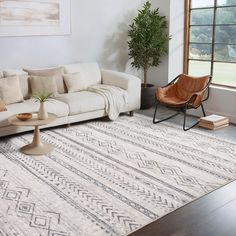 a living room with a couch, chair and rug