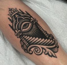 a black and white tattoo on the leg of a man with an eye in it