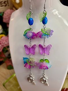 🌸🌱Bellflower, Pink, Purple, Blue Flowers, Fairy Charm, Butterfly Earrings, Dangly Cottagecore, Gift ideas, Y2K, Whimsical, Fairycore ️🍓✨ᠻ𝚊𝚒𝚛𝚢 𝚑𝚊𝚗𝚍𝚖𝚊𝚍𝚎 𝚓𝚎𝚠𝚎𝚕𝚛𝚢🍄🍃 🚚 𝔸𝕝𝕨𝕒𝕪𝕤 𝕗𝕣𝕖𝕖 𝕤𝕙𝕚𝕡𝕡𝕚𝕟𝕘! 🌸 𝐻𝒶𝓃𝒹𝓂𝒶𝒹𝑒 𝓌𝒾𝓉𝒽 𝓁𝑜𝓉𝓈 𝑜𝒻 𝓁𝑜𝓋𝑒 💕 ✨𝙵𝚛𝚎𝚎 𝚜𝚞𝚛𝚙𝚛𝚒𝚜𝚎 𝚐𝚒𝚏𝚝 𝚊𝚗𝚍 𝚌𝚞𝚝𝚎 𝚜𝚝𝚒𝚌𝚔𝚎𝚛𝚜 𝚠𝚒𝚝𝚑 𝚎𝚟𝚎𝚛𝚢 𝚙𝚞𝚛𝚌𝚑𝚊𝚜𝚎✨ ♡Shipping Info♡ I usually ship the next day with USPS. Tracking info is available on Etsy, US orders usually arrives in 2-3 days after being shipped. ♡ Packaging Details ♡ All jewelry is set on a cute jewelry display card with cute stickers and a lovely handwritten note. ♡ Risk-free Guarantee ♡ We know how important it is for your order to be perfect. If you're dissatisfied in any way, please send us a mess Y2k Whimsical, Purple Blue Flowers, Diy Earrings Dangle, Handmade Jewelry Display, Handmade Earings, Lucite Flower Earrings, Jewelry Display Cards, Fairy Charms, Pink Purple Blue