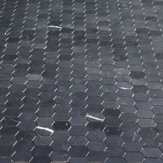 an image of a black tiled floor that looks like hexagonal tiles