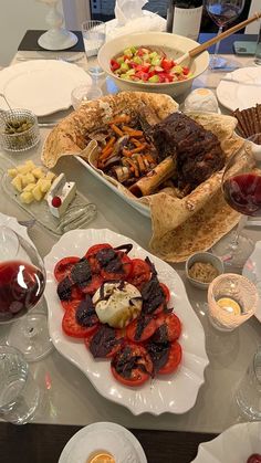 a table filled with plates and bowls of food