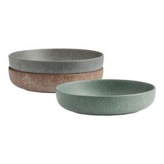 two bowls sitting next to each other on a white background