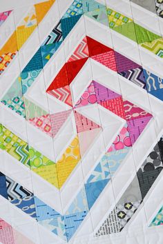 a close up of a colorful quilt on a table