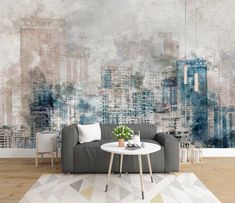 a living room with a couch and table in front of a large cityscape wall mural