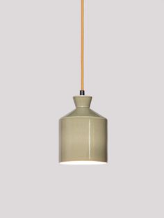 a light that is hanging from a ceiling fixture with a wooden stick sticking out of it