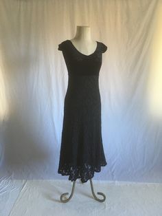 "vintage 1990s dress Betsey Johnson made in USA black velvet top high waist black lace skirt lined skirt acetate, polyamide, elastomer, lace blend, nylon (skirt lining) pull over wide scoop soft v neck and back cap sleeve velvet top is very soft w/slightly crushed affect, w/some stretch lace skirt is see through w/stretchy nylon lining good vintage condition, light wear label size P(etite) measures, lying flat, neck opening width-9 1/2\" neck to sleeve-4\" chest-15\" and stretches to 18\" waist-12 1/2\" and stretches to 16\" length from top to waist-11 1/2\" total length-4\"" 90s Betsey Johnson, Nylon Skirt, 1990s Dress, Black Velvet Top, Skirt Lining, Black Lace Skirt, Draped Blouse, Velvet Top, Velvet Lace