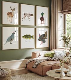 a living room filled with furniture and pictures on the wall