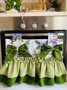 the oven is covered with green and white ruffles