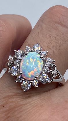 Vintage Ethiopian Opal Band 925 Sterling Silver Ring All pave set Cubic Zirconia and Ethiopian opal in Rhodium Sterling Silver to prevent tarnish Size 6, 7, 8 or 9.25 Can be re sized for a $10-$20 fee PLEASE add ring size to notes in your order!! Thanks. All rings are shipped in a nice gift box. Check out our over a THOUSAND great reviews Engraving is $4 per letter and is not always perfect depending on the piece. It can take a few days if the jeweler is busy. This is payable to Paypal Judithslt Silver Opal Ring With Multi-stone Round Cut, Silver Multi-stone Round Cut Opal Ring, Silver Opal Ring With Accent Stones, Round Cut, Silver Multi-stone Opal Ring As Gift, Silver Opal Ring With Round Cut, Silver Opal Multi-stone Ring, Opal Jewelry With Center Stone In White Gold, White Gold Opal Jewelry With Center Stone, Silver Opal Diamond Ring Fine Jewelry