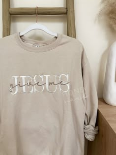 "Embroidered Give Me Jesus Sweatshirt. Embroidery size: approximately 11\" in length (across chest) Sizes: UNISEX Small, Medium, Large, XLarge, 2Xlarge -Fit is a little loose Color: Sand Thread: White & Beige Wash & Care: -Wash in cold water with like colors on a gentle cycle -Tumble dry low or hang to dry PROCESSING/TURNAROUND TIME: -Processing/Turn around times may vary. Please check the estimated ship/delivery times.  -Processing/Turn around time DOES NOT include shipping time. *PLEASE NOTE c Christian Crew Neck Sweatshirt, Christmas Shirts Christian, Relaxed Fit Embroidered Cream Sweatshirt, Cream Embroidered Relaxed Fit Sweatshirt, Long Sleeve T-shirt With Custom Embroidery In Relaxed Fit, Cream Cotton Top With Letter Embroidery, Cream Cotton Tops With Letter Embroidery, Christian Embroidered Sweatshirt, Cute Embroidered Sweatshirt