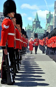 a group of men in red uniforms marching down a street