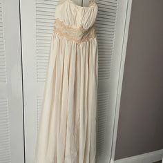 a white dress hanging on a door