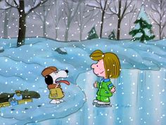 a child and dog playing in the snow