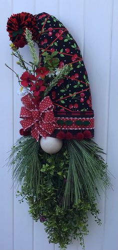 a wreath with flowers and an egg hanging on the wall