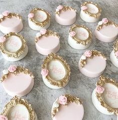 some pink and gold decorated cookies on a table