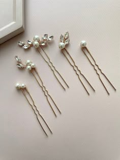 Indulge in elegance with our set of 5 exquisite bridal hair pins. Crafted from top-tier materials including crystal rhinestones, lustrous pearl beads, and silver-plated jewelry wire, these wedding hair pins are customizable with a range of rhinestone colors.  Discover the timeless elegance of our pearl hair pins, meticulously crafted to grace the hairstyles of brides, bridesmaids, and prom-goers alike. Radiating sophistication and grace, these pearl hair pins are the quintessential accessory for those seeking refined beauty on their special day. Their versatility effortlessly complements the bridal ensemble, adding a touch of glamour and charm. Whether adorning the bride's hair with understated grace or accentuating the bridesmaids' styles with elegance, these pins are a statement of endur Hair Accessories For Prom, Pearl Pins In Hair, Wedding Hair Pearls, Pearl Wedding Accessories, Decorative Hair Pins, Pearl Wedding Hair, Hair Piece Wedding Hair, Wedding Bun, Bride Hair Pins