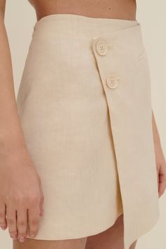 An update on the classic mini skirt, it sits high on the waist and has an off-centre front button fastening. Cut from linen and viscose-blend, it has a wrap front that creates an asymmetric hem. Style yours with a matching vest. 55% Linen, 28% Viscose, 16% Cotton, 1% Elastane  Dry-clean only Classic Mini Skirt, Georgia Hardinge, Knitwear Outfit, Wrap Mini Skirt, Custom Made Clothing, Sleep And Loungewear, Eugenia Kim, Lingerie Outfits, Dresses By Length