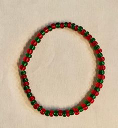 A Red and Green bracelet that you can wear during the Christmas season or just whenever you want! Casual Red Bracelets For Party, Festive Christmas Bracelets With Round Beads, Holiday Festive Jewelry Bracelet, Christmas Festive Round Beads Bracelets, Christmas Holiday Bracelet Jewelry, Christmas Holiday Jewelry Bracelet, Christmas Beaded Stretch Bracelet Gift, Adjustable Beaded Bracelets For Party And Holiday, Adjustable Beaded Bracelets For Holiday Party