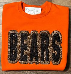 Show your school spirit with this unique shirt. Comfort, casual and loose fitting, made on 50/50 cotton/poly blend shirts.  Embroidered leopard and sequin Bears sweatshirt.  Turn around time is 7 business days for this style of shirt. We make all shirts in our shop.  Please message us if you have a custom color request.  You can follow us at the below link for chances to win giveaways and to see all of our latest creations.  https://www.facebook.com/groups/710060383256657/?ref=share&mibextid=S66gvF Embroidered School Spirit Tops For Fall, School Spirit Tops With Embroidered Graphics For Fall, Fall Tops With School Spirit Letter Embroidery, Embroidered Fall College T-shirt, School Spirit T-shirt With Letter Embroidery For Fall, Fall School Spirit T-shirt With Letter Embroidery, Embroidered Graphics T-shirt For College In Fall, Fall Varsity T-shirt With Embroidered Graphics, Fall T-shirt With Embroidered Graphics For School Spirit