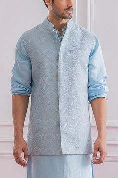 Powder blue Nehru jacket with floral lucknowi intricate hand embroidery and mandarin collar.
Component: 1
Pattern: Embroidered
Type Of Work: Lucknowi
Neckline: Mandarin
Sleeve Type: Sleeveless
Fabric: Pure Georgette
Color: Blue
Other Details: 
Hand embroidery
Closure: Front concealed buttons
Note: Inner kurta and churidar worn by the model is not for sale
Occasion: Destination Wedding - Aza Fashions Indo Western Outfits For Men Engagement, Nehru Jacket With Kurta, Indo Western Outfits For Men, Engagement Dress For Groom, Indian Wedding Clothes For Men, Nehru Jacket For Men, Sleeveless Kurta, Haldi Outfits, Sequence Embroidery