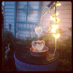 a small table with some food on it in the middle of a yard next to a house