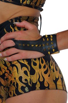 The black and gold leather spike cuff bracelets are giving new meaning to hand armor! This jewelry accessory is a cross between gold fingerless gloves and a leather cuff bracelet. Inspired by punk and glam rock aesthetics, and designed to make a statement, these spike bracelet cuffs are perfect for everything from festival outfits to going out Friday night. FEATURES: Made with black, and gold foiled sheepskin leather Finger loop Gold Spike detailing Adjustable snaps at the wrist Ethically handma Hand Armor, Punk Glam, Gloves Dress, Bracelet Cuffs, Spike Bracelet, Bracelet Inspired, Punk Aesthetic, Arm Cuff, Leather Cuffs Bracelet