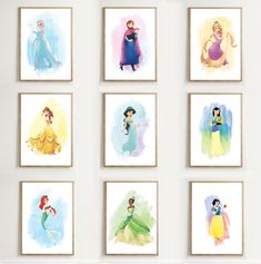 the disney princesses are hanging on the wall in this room with white walls and framed pictures