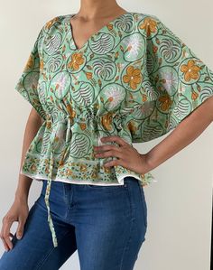 Blouses are made of Indian hand block cotton fabric in beautiful prints. Total 6 prints available, choose your option from drop down menu!  It is made to fit few sizes of 2 to 12 easily, please check measurements!  Great for work/outings/vacations.  Length - 21.5" Bust - fits up to 43" of bust all around.  Waist - fits up to 37" of waist all around. My bust is 36" and waist is 28" for reference. Caftan blouse has drawstring waist for a cinched waist look. You can adjust accordingly!! If you like Green Printed V-neck Top, Casual Tops With Spring Printed Motifs, Casual Spring Tops With Printed Motifs, Casual Multicolor Blouse With Printed Motifs, Summer Cotton Blouse With Printed Motifs, Casual Printed Motifs Tops For Summer, Fitted Tops With Printed Motifs For Summer, Cotton Summer Blouse With Printed Motifs, Cotton V-neck Top For Beach