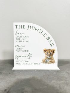 the jungle bar sign with an image of a lion cub on it's back