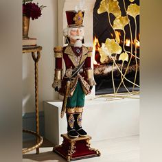 a christmas nutcracker standing in front of a fireplace