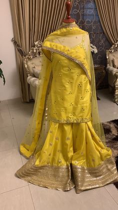 Pakistani indian designer dress Embroidered Kurta Set Evening Party Dress Bridesmaid Gift Minimalist Dress, Bohemian Simple Wedding Dress  About This Item Introducing the Mayon Bride from United Kingdom, a stunning addition to any bridal collection. This beautiful ensemble features a lemon yellow silk sharara set with intricate mirror and gotta work embellishments, adding an elegant touch to any special occasion. High-quality silk material Mirror and gotta work embroidery Comfortable and stylish sharara set The Mayon Bride exudes grace and sophistication. The lemon yellow color adds a pop of vibrancy to your wardrobe, while the mirror and gotta work embroidery provide an eye-catching detail that is sure to turn heads. This ensemble is made with high-quality silk material that feels soft ag Unstitched Anarkali Dress In Art Silk, Chanderi Dress For Navratri With Traditional Drape, Navratri Chanderi Dress With Traditional Drape, Semi-stitched Dresses For Navratri With Traditional Drape, Semi-stitched Traditional Drape Dresses For Navratri, Semi-stitched Dresses For Navratri, Yellow Chanderi Dress With Mirror Work, Semi-stitched Raw Silk Dress With Gota Work, Designer Tissue Silk Dress With Resham Embroidery