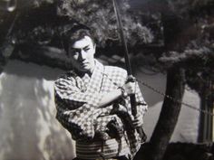 an old black and white photo of a man holding a baseball bat