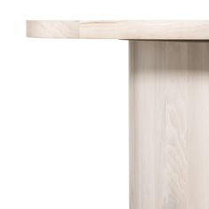 a close up of a wooden table with a white surface and light wood grains