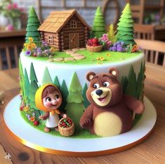 there is a cake decorated with cartoon characters on the top and trees in the background