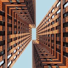 an upward view of some tall buildings