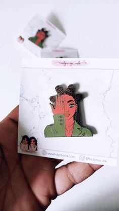 a person holding up a sticker with an image of a woman in the background