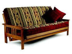 a wooden futon sofa with two pillows on it's back and one arm