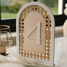 a table with a clock on it next to a candle holder and some white fur