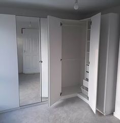 an empty room with white walls and closets