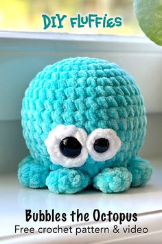 a blue crocheted octopus stuffed animal sitting on top of a window sill