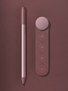 a pen and remote control on a brown surface