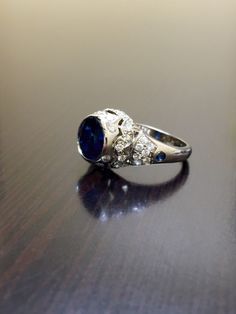 DeKara Designs Clearance Metal- 14K Yellow Gold, .583. Stones- Center 1 Round Ceylon Blue Sapphire 2.25 Carats, 2 Round Sapphire 0.05 Carats, 40 Diamonds G Color VS2 Clarity, 0.72 Carats. Size- Ring is a 6, and could be sized up or down at no additional cost! FREE SIZING Want the ring entirely hand engraved? No problem! Just go to the following link... https://www.etsy.com/listing/280526214/art-deco-14k-white-gold-sapphire-diamond?ga_search_query=sapphire+ring&ref=shop_items_search_8 Art Dec Luxury Wedding Ring With Accent Stones, Luxury Formal Rings With Lab-created Sapphire, Formal Sapphire Diamond Cut Ring, Luxury Lab-created Sapphire Ring For Formal Occasions, Formal Sapphire-colored Diamond Ring, Luxury Cluster Ring With Sapphire In Round Cut, Luxury Sapphire Cluster Ring With Round Cut, Luxury Blue Ring With Diamond Accents, Exquisite Sapphire Rings With Brilliant Cut