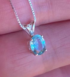 "Beautiful, dainty/minimalist, but will definitely not gone unnoticed, natural, paraiba, and paraiba color: known for its bright neon colours. The colour ranges from blue to green. Stone size: 7*5mm, 0.90 carats, set in 925 sterling silver, with 18\" inches long sterling silver box chain." Blue Minimalist Aquamarine Jewelry, Blue Emerald Gemstone Necklace As Gift, Blue Emerald Gemstone Necklace For Gift, Dainty Blue Aquamarine Jewelry, Green Blue Topaz Jewelry Gift, Green Blue Topaz Jewelry For Gift, Bloodstone Necklace, Apatite Necklace, Green Apatite