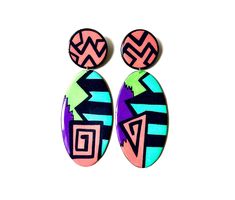 "Looking for a vibrant pair of handmade statement earrings to add to your collection? Look no further. The sharp geometric shapes and bold colors will certainly turn heads. As always, each pair is extremely lightweight, easy to wear, and made to order! Please allow 3-4 days for processing.  Dimensions: H: 4.5\" W: 1.75\" Care Notes  Avoid extreme moisture  Store in a dry place  Do not bend" Bold Geometric Designed Earrings, Bold Geometric Earrings With Bold Design, Bold Geometric Earrings, Bold Drop Earrings With Bold Design, Modern Multicolor Earrings With Bold Design, Bold Handmade Geometric Earrings, Handmade Multicolor Oval Earrings, Bold Handmade Multicolor Earrings, Bold Handmade Colorful Earrings