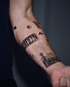 a man's arm with an image of the city on it and his hand